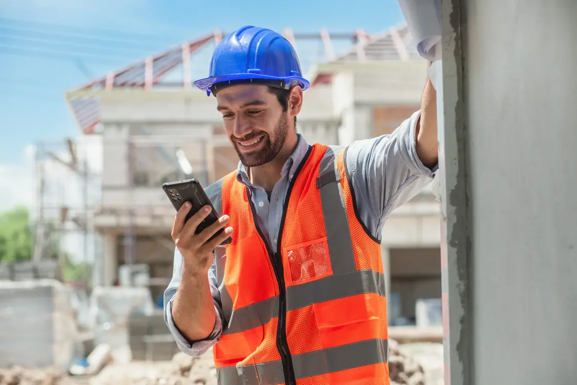 Contractor smiling while using his phone to video call with a client who has contacted BFG Innovations